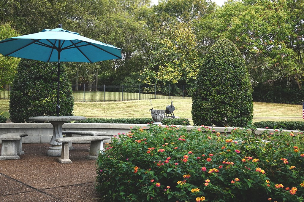 a picnic table with an umbrella in a park