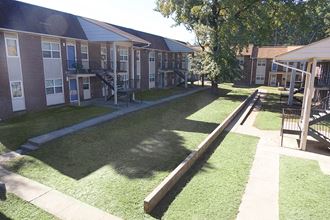 a view of a yard in front of an apartment building