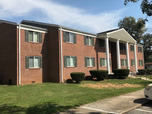 a brick building with white columns in front of it