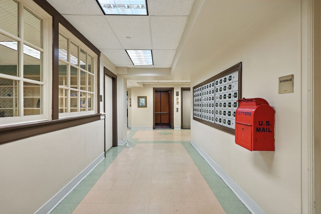 A long hallway with a U.S. Mail box on the wall.