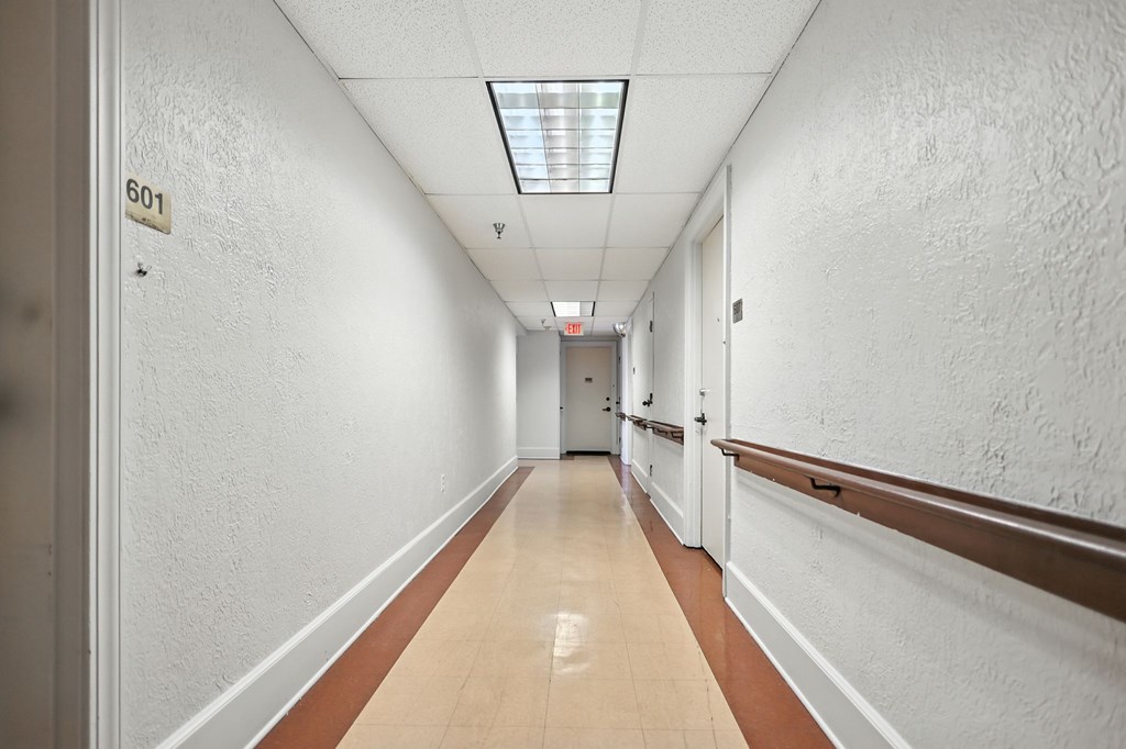 A long hallway with a door at the end.
