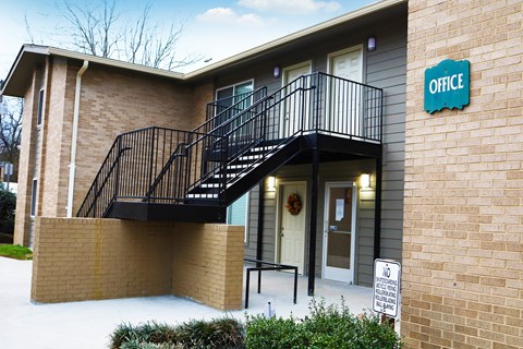 the outside of an office building with stairs and a door