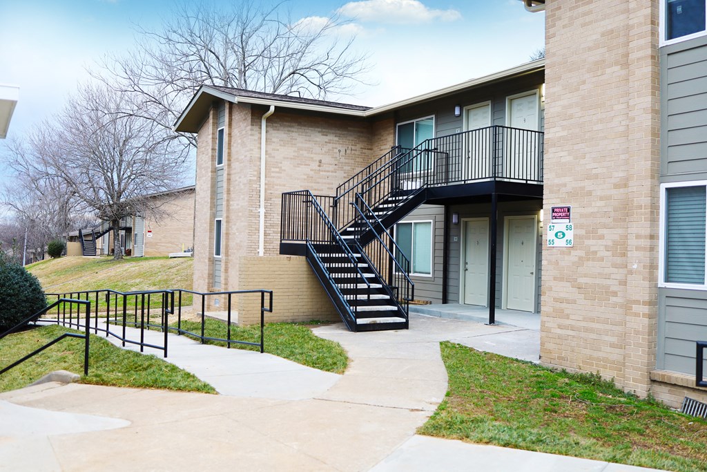 the exterior of a building with stairs and a sidewalk