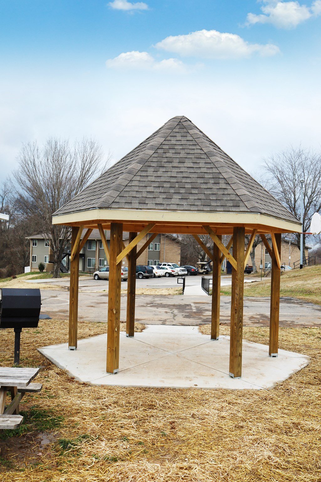 a gazebo with a roof in a parking lot