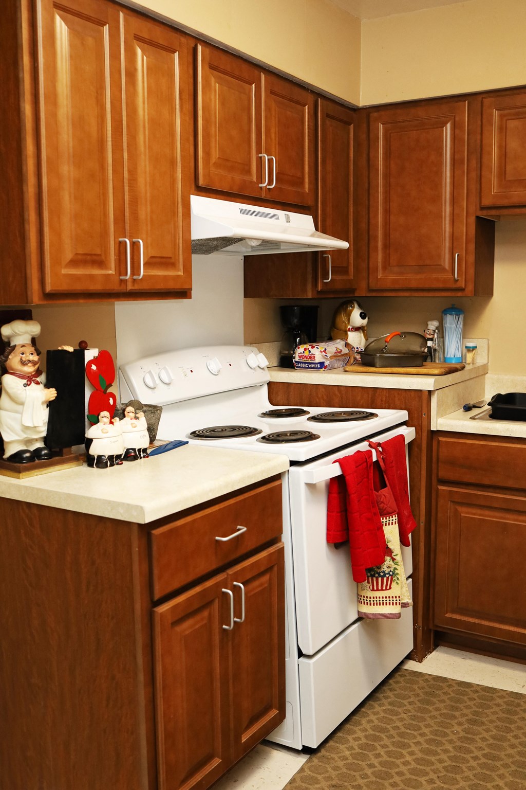 a kitchen decorated for christmas with christmas stockings on the stove