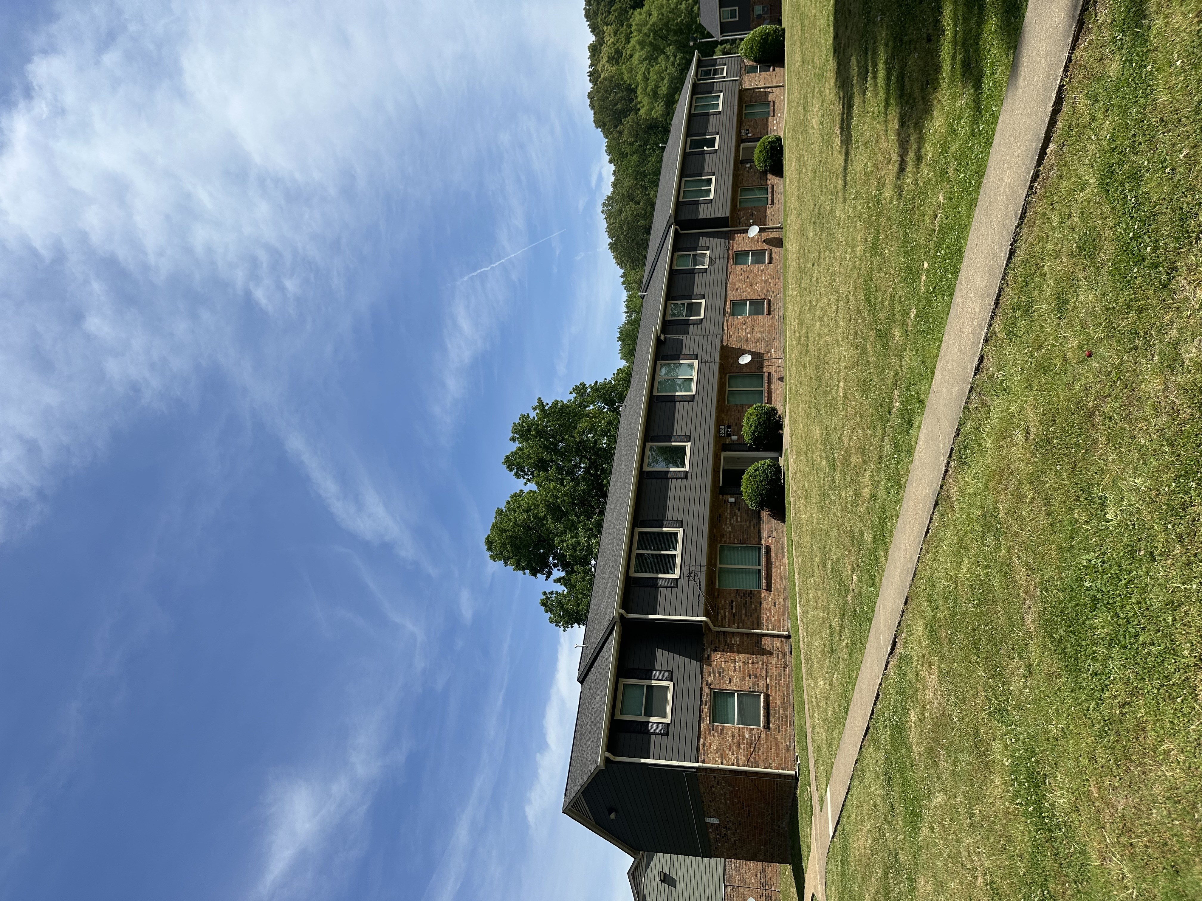 A building with a green lawn in front of it.