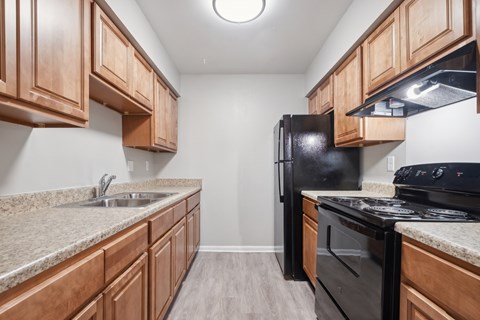 A Kitchen With Black Appliances at Fair Oaks Apartments, Little Rock, 72204