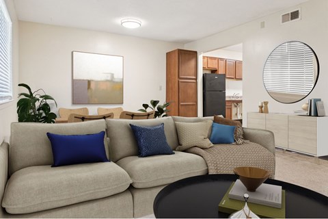 A living room with a grey couch and a coffee table.