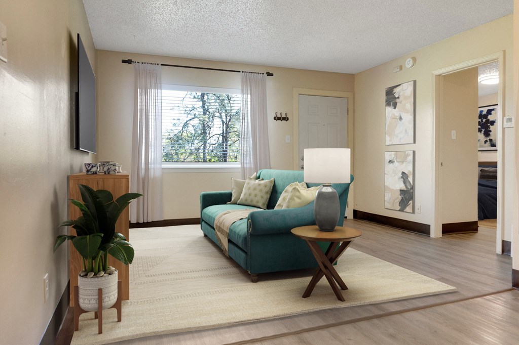 A living room with a blue couch and a wooden table.