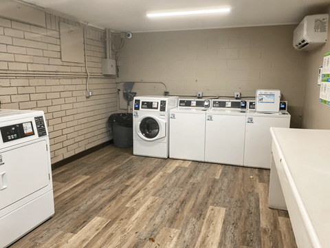 A row of washing machines in a laundromat.