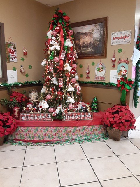 a christmas tree in the corner of a room