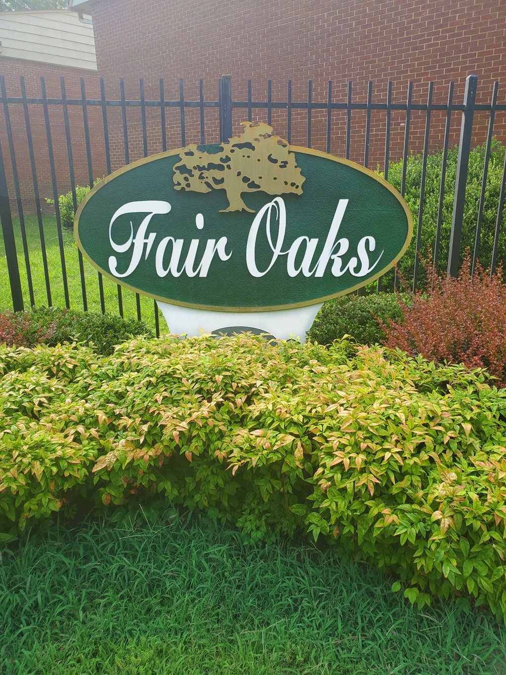 a sign for fair oaks in front of a fence