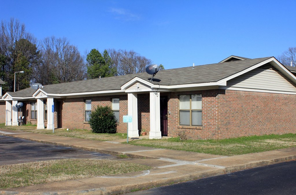 a brick building with a satellite dish on the roof
