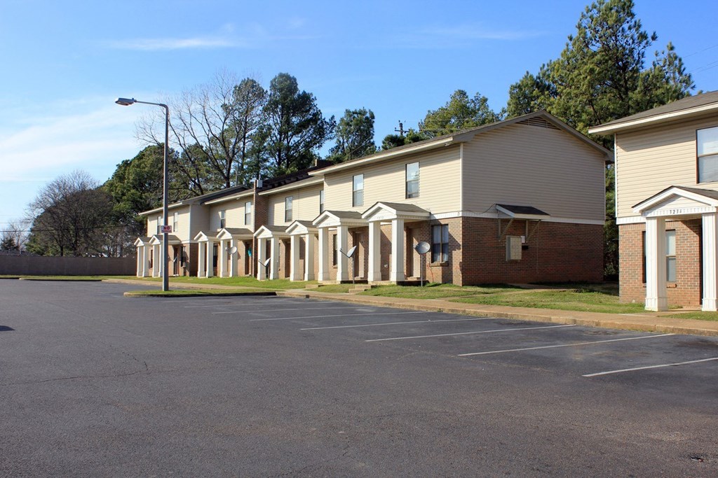 a row of apartment buildings on the side of a road