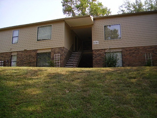 a tan house with a staircase in front of it