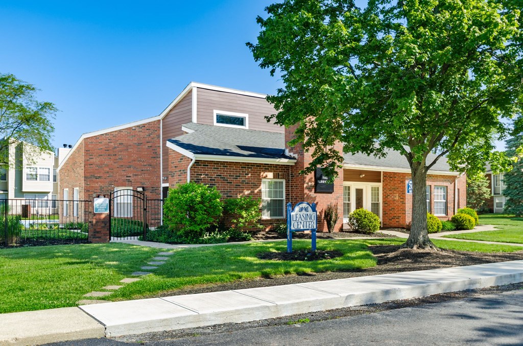 A brick building with a sign that says "Farm Boy" in front of it.