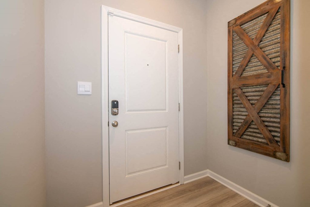 a white door in a room with a wall art at Jackson Run Townhomes, Whitestown Indiana