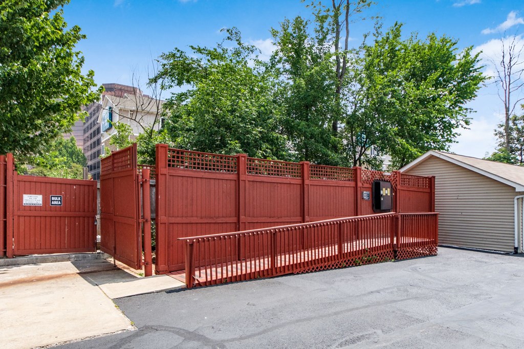 a red fence in front of a house with a parking lot at Prescott Place, Columbus, OH