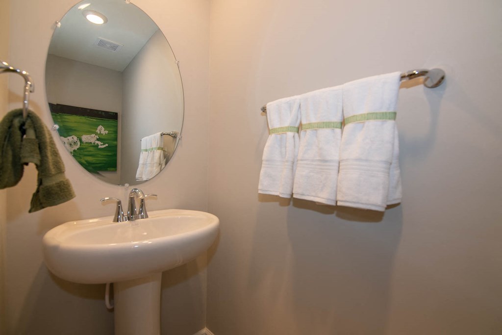 a small bathroom with a sink and a mirror at Jackson Run Townhomes, Whitestown, 46075