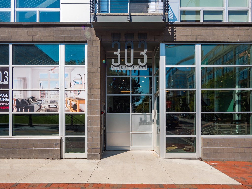 The entrance to a building with a glass door and a sign that reads "303".
