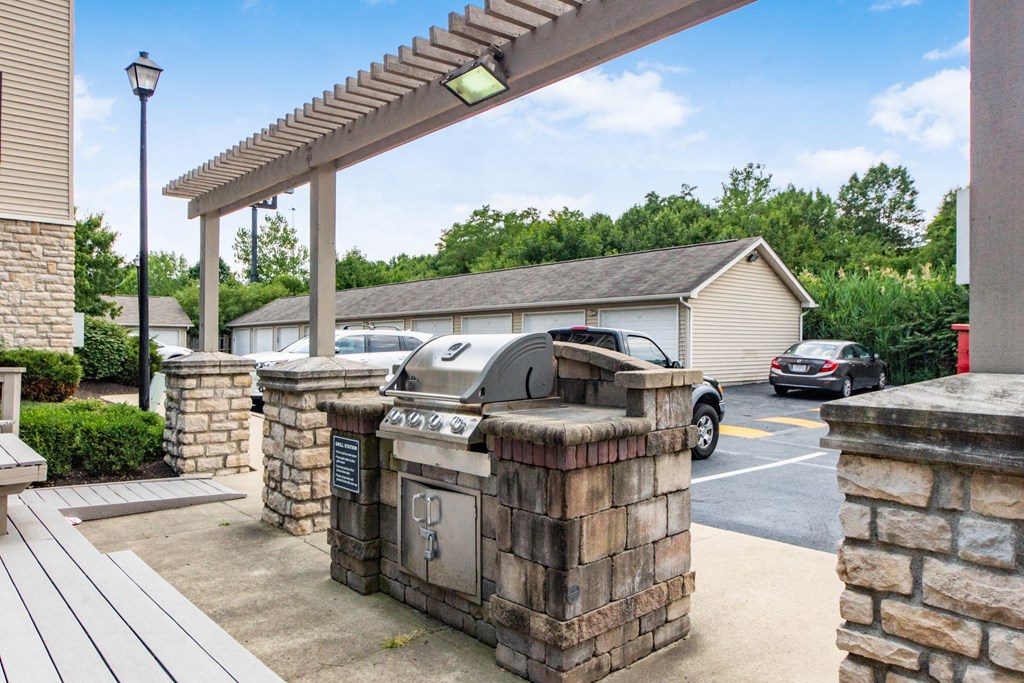 a covered patio with a grill and a parking lot at Prescott Place, Columbus, OH