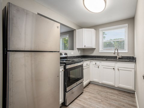 a kitchen with stainless steel appliances and white cabinets