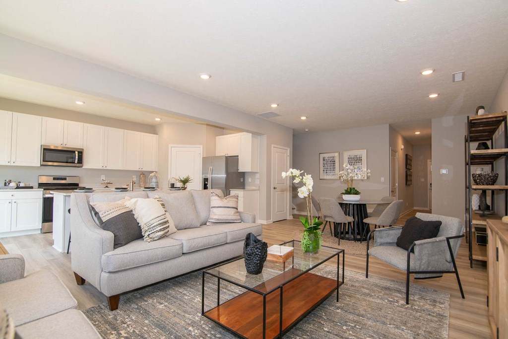 a living room with a couch and a table at Jackson Run Townhomes, Whitestown, IN