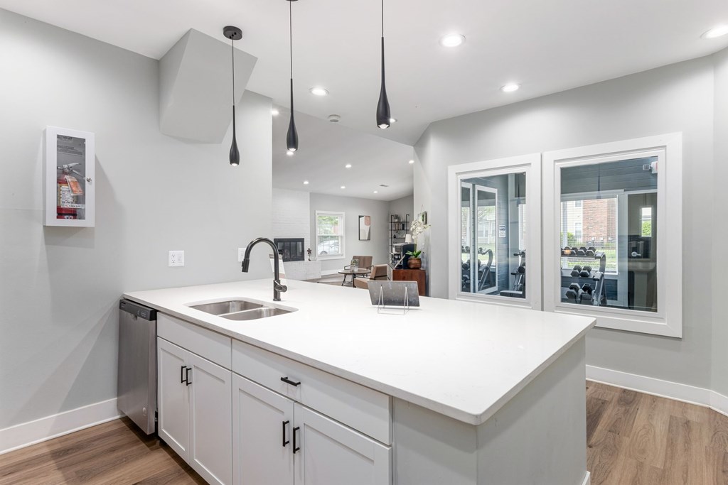 A modern kitchen with white countertops and cabinets.