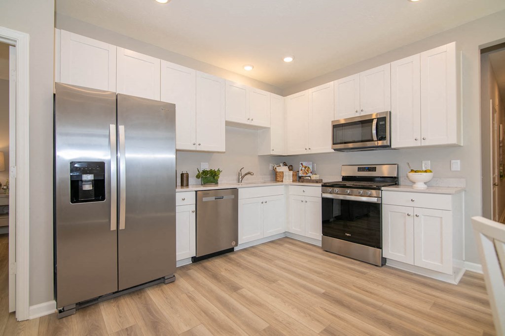 a kitchen with stainless steel appliances and white cabinets at Jackson Run Townhomes, Indiana, 46075