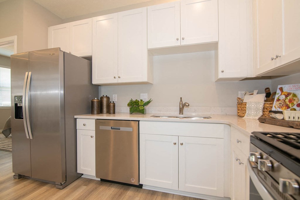 a kitchen with white cabinets and a stainless steel refrigerator at Jackson Run Townhomes, Whitestown, 46075