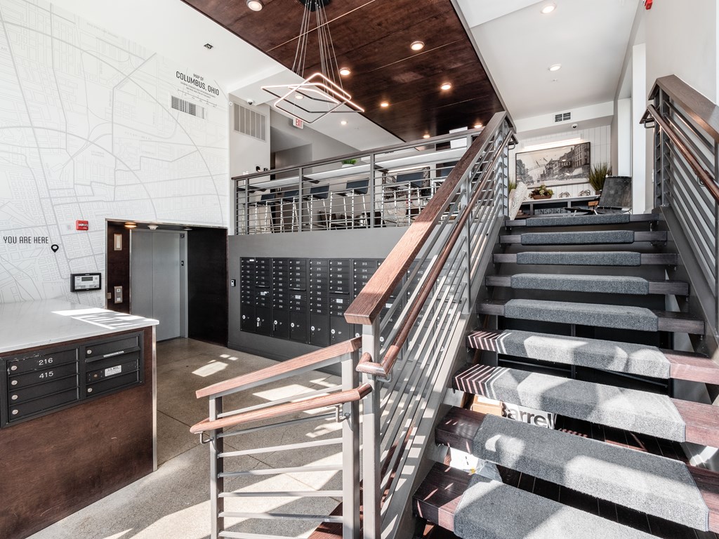 A staircase with a metal railing and wooden steps.