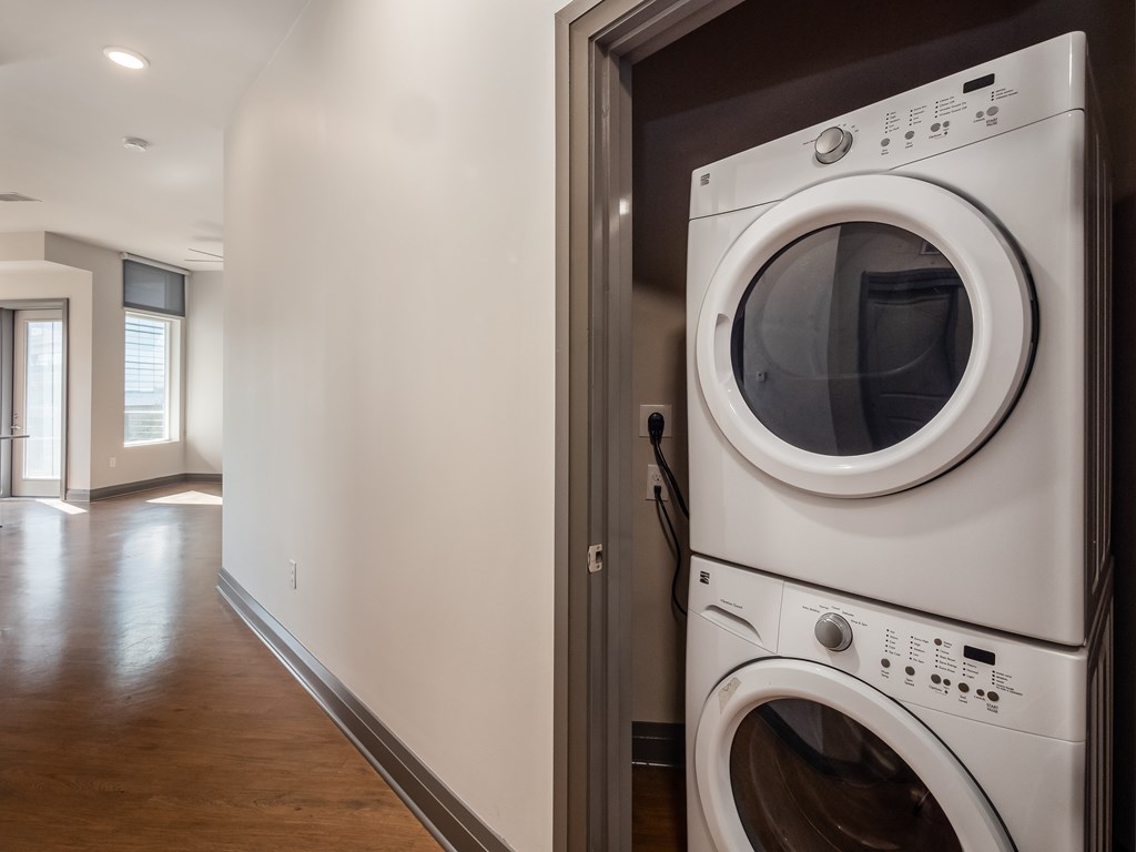 A white washing machine is in a doorway.