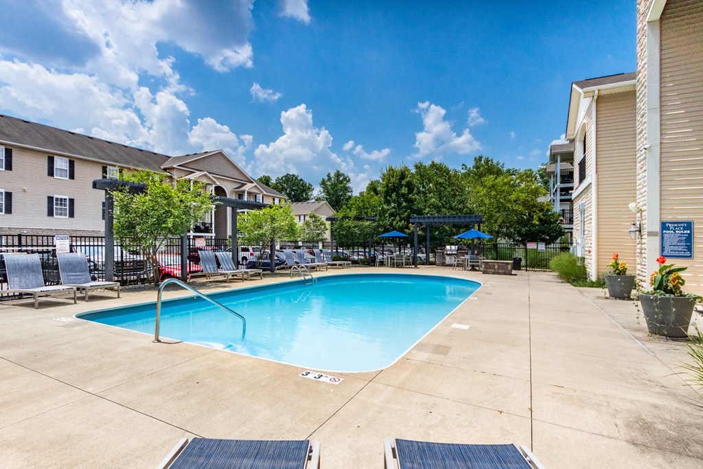 our resort style swimming pool is surrounded by our apartments and has a blue sky background at Prescott Place, Ohio, 43235