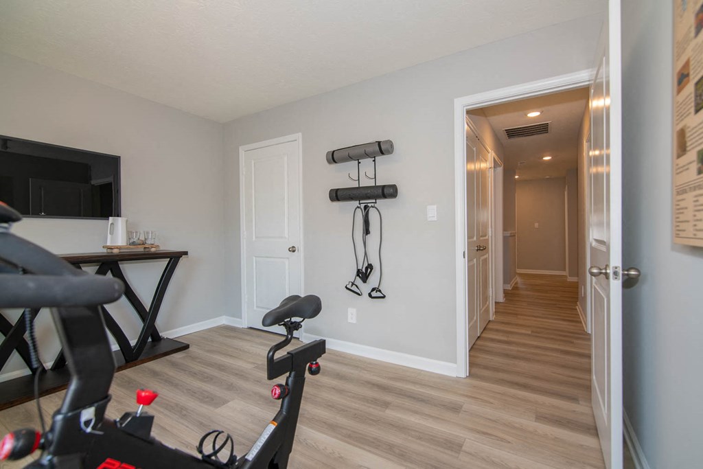 a home gym with weights and a tv at Jackson Run Townhomes, Whitestown Indiana