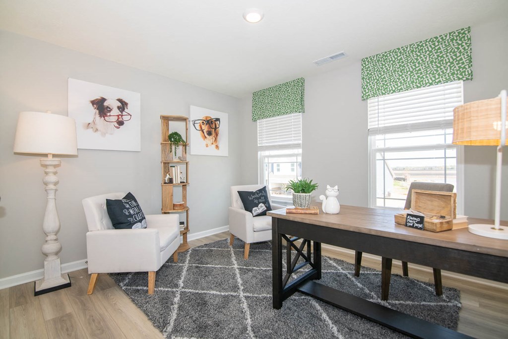 a living room with a table and chairs and a window at Jackson Run Townhomes, Whitestown