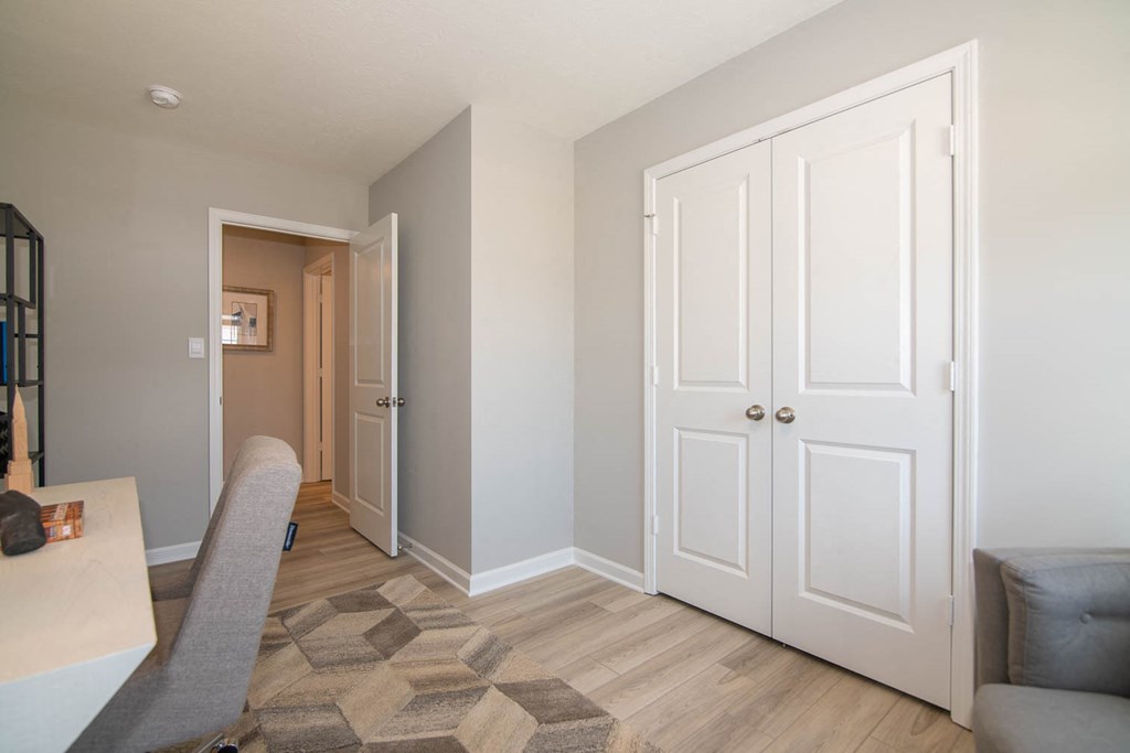 a living room with white doors and a hallway to a bedroom at Jackson Run Townhomes, Whitestown, IN