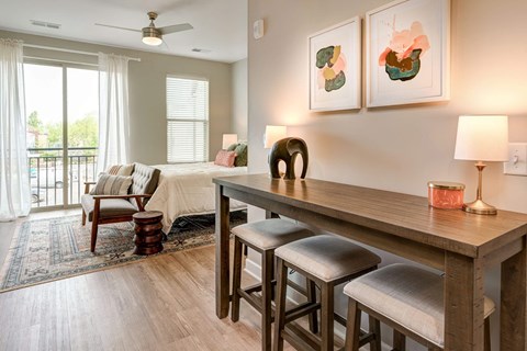 a living room and dining room with a table and chairs