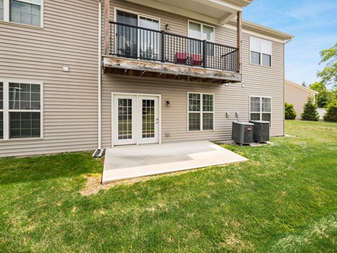 A two-story apartment building with a balcony and a driveway. at River View at Bexley Apartments, River View at Bexley, OH, 43209