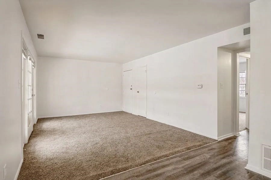 a room with a carpeted floor and white walls