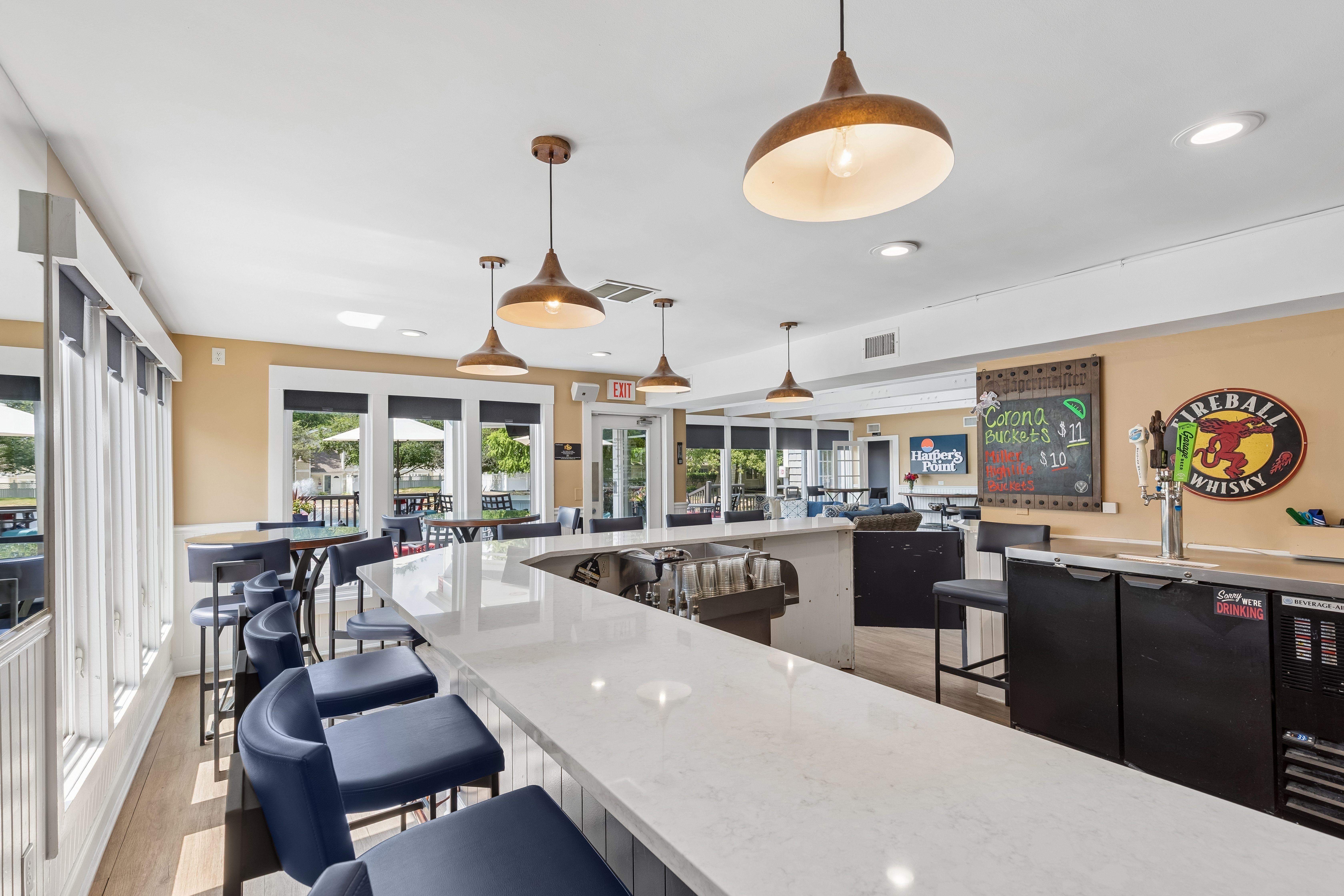 A restaurant with a bar area and a menu board on the wall.