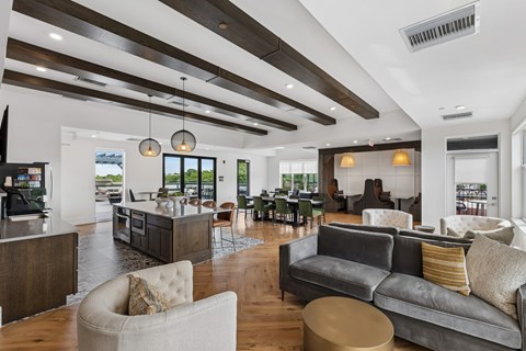 A modern living room with a grey couch and a wooden ceiling.