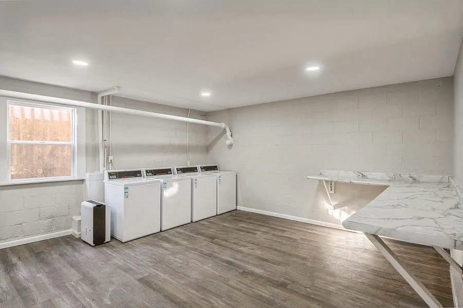 a room with two washers and a sink