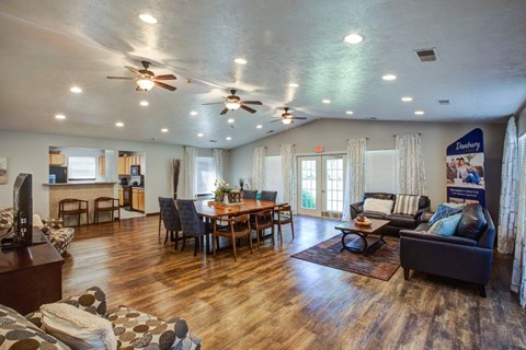 A spacious living room with a dining table and chairs.