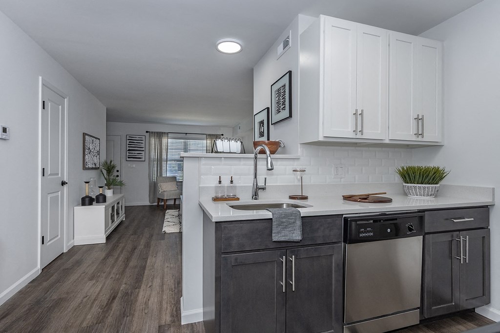 a renovated kitchen with white cabinets and stainless steel appliances