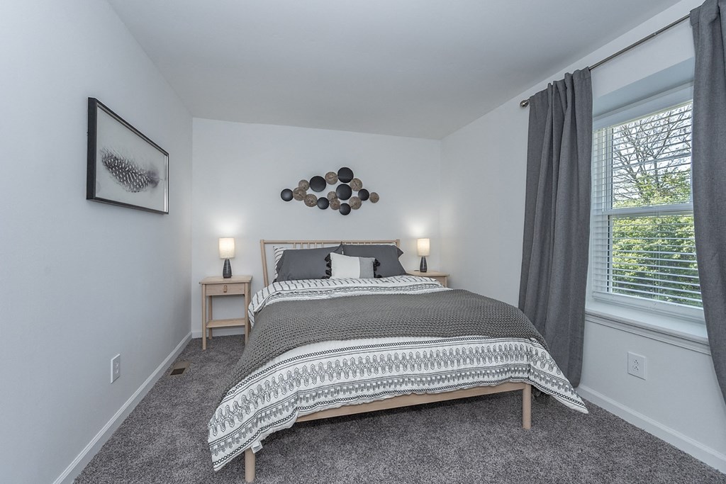 a bedroom with a bed and a window