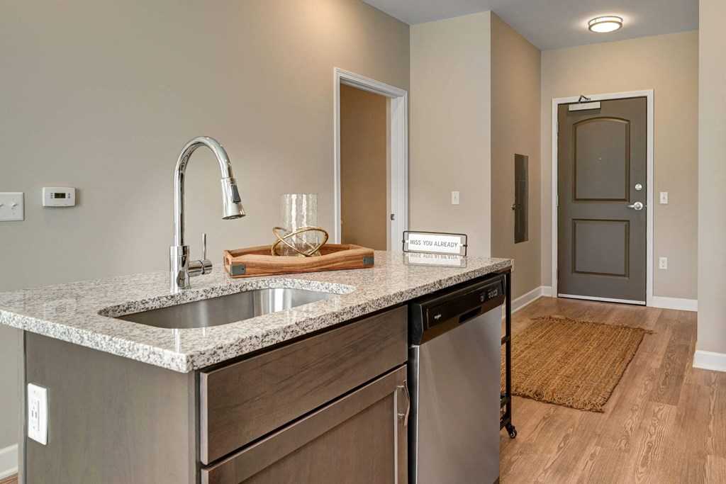 a kitchen with a sink and a door to a hallway at Adelphi Quarter, Columbus, OH, 43203