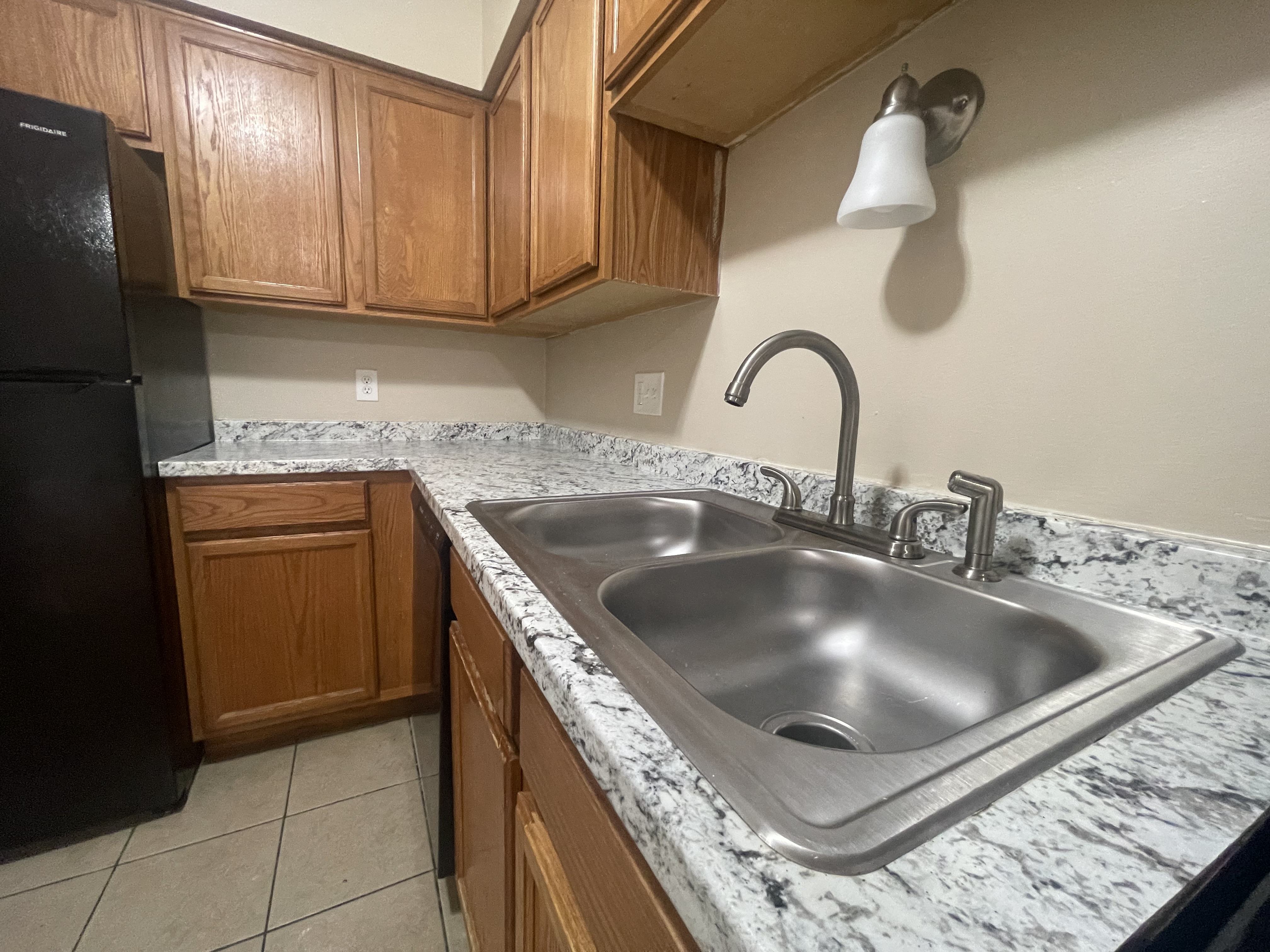 a kitchen with a sink and a refrigerator