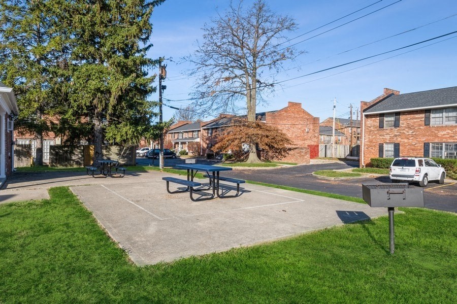 a picnic area with a picnic table and a grill