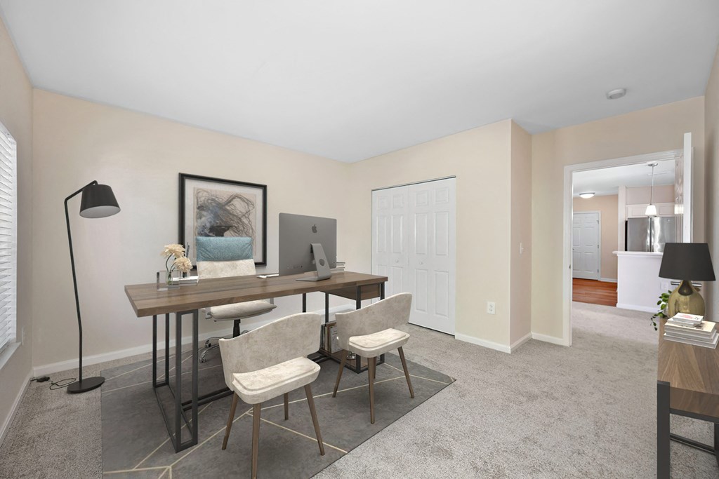 a home office with a desk and chairs and a computer