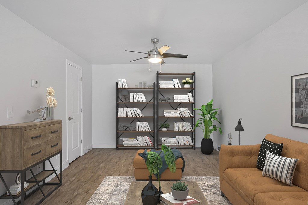 a living room with a couch and a ceiling fan